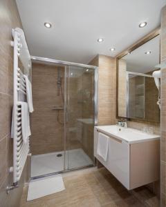 a bathroom with a shower and a sink at Bükkös Hotel & Spa in Szentendre