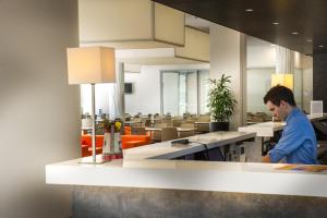 a man standing at a counter in a restaurant at Holiday Inn Express Strasbourg Centre by IHG in Strasbourg