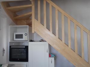 a stairway with a microwave and a refrigerator at Ti va zud in Plouguerneau