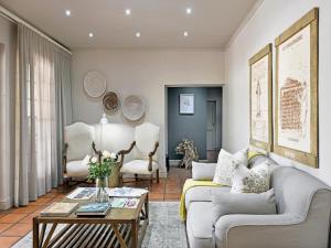 a living room with a couch and a table at Mont d'Or Franschhoek in Franschhoek