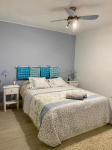 a bedroom with a large bed and a ceiling fan at Apartamento Navío in Gandía