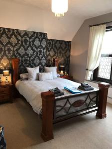 
a bedroom with a large bed and a large window at Ty Mynydd Lodge in Cardiff
