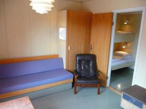 
a small room with a bed and a chair at Dovre Motel in Dovre
