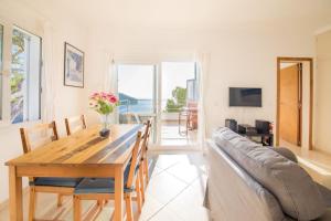 a living room with a table and a couch at Ponent in Port de Soller