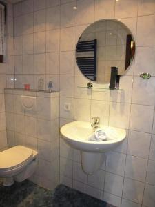 a bathroom with a sink and a toilet at Haus 2 - Typ A (Appartement) in Schönecken