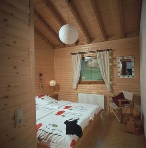 a bedroom with a bed in a wooden cabin at Haus 1 - Typ B (Blockhaus) in Schönecken