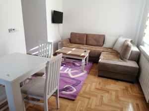 a living room with a couch and a table at Vila Meridijan in Zlatibor