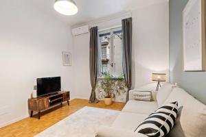un soggiorno con divano e TV di Gorgeous flat in the Design District a Milano