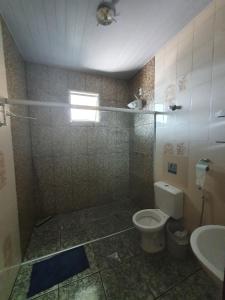 ein Bad mit einer Dusche, einem WC und einem Waschbecken in der Unterkunft Hostel Jussa in Belo Horizonte