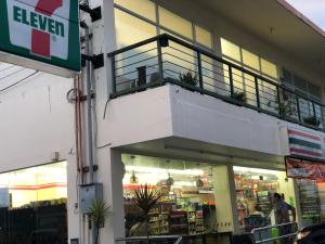 a store with a balcony on the side of a building at Cebu-Mactan Condo in Mactan
