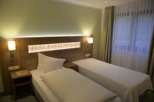 מיטה או מיטות בחדר ב-Hotel- Landgasthof Baumhof-Tenne
