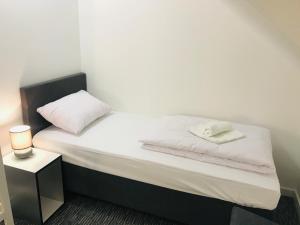 A bed or beds in a room at R plius "Easy Kaunas"