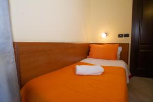 Postel nebo postele na pokoji v ubytování Hotel Merlino