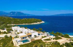 an aerial view of a house on a hill next to the ocean at KEROMOUSSI SEASIDE BOUTIQUE HOTEL - Adult only in Meganisi