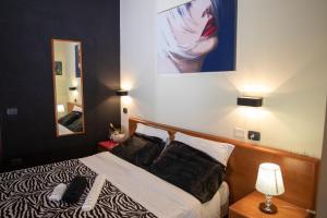 Postel nebo postele na pokoji v ubytování Hotel Merlino