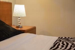 Postel nebo postele na pokoji v ubytování Hotel Merlino