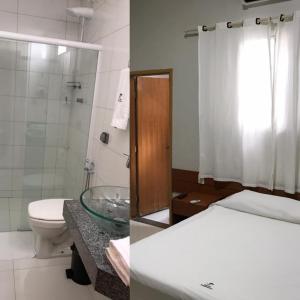 a bathroom with a toilet and a bathroom with a shower at Hotel Itamarati in Uberlândia