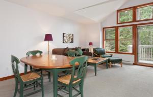 a living room with a table and chairs and a couch at Treeline Townhome by Whistler Premier in Whistler