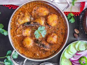 a pan of food with meatballs in a curry at Mountain Village Stay - Dharali Heights Harsil in Harsil