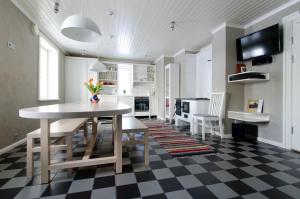 a kitchen with a table and chairs in a room at Joosti Puhkemaja in Tõutsi