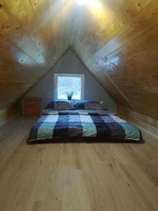 a bedroom with a bed in a attic at Domek Bobrowe Zacisze w Górach Sokolich in Karpacz