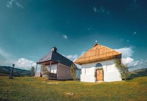 une petite église avec toit sur un champ dans l'établissement CENTRAL APARTMAN, à Gheorgheni