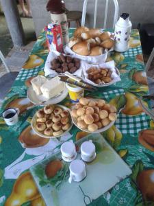 a table with plates of food on top of it at Hostel Jussa in Belo Horizonte