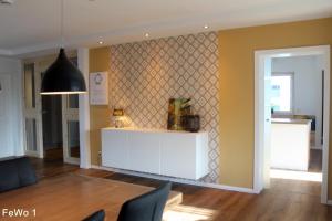 a living room with a white counter and a wall at Harry`s FeWo in Willingen