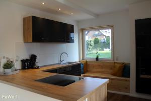 a kitchen with a sink and a large window at Harry`s FeWo in Willingen