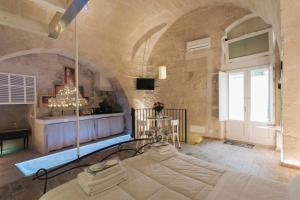 a large room with a stone wall and a door at LUX LUCIS in Matera