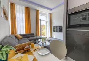 a living room with a couch and a tv at Elenas Rooms & Apartment in Zagreb