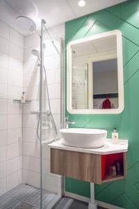 a bathroom with a sink and a shower at Good Morning Arlanda in Arlanda