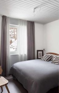 a bedroom with a large bed and a window at IRIS TOP 3 DESIGN APARTMENT in Bad Kleinkirchheim