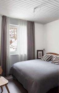Un dormitorio con una cama grande y una ventana en IRIS TOP 3 DESIGN APARTMENT, en Bad Kleinkirchheim