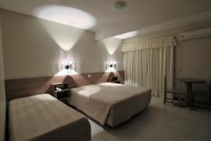 a hotel room with a bed and a table at Hotel Costa Dalpiaz in Torres +73 photos