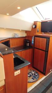 a kitchen with wooden cabinets and a black counter top at Little Pearl in Boston