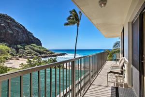 a balcony with a view of the ocean and a palm tree at Stunning Makaha Condo with Pool Access and Ocean View! in Waianae