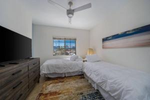 a bedroom with two beds and a flat screen tv at The Playa in Indio +23 photos