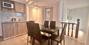 a dining room table and chairs in a kitchen at CARO Boutique Guest House in San Ġwann