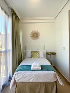 A bed or beds in a room at Playa de Levante Sea View Apartment