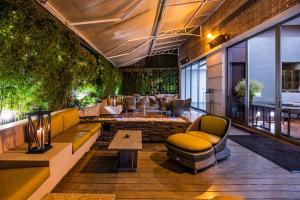 a living room with a couch and chairs and a table at Hotel Cabrera Imperial By key 33 in Bogotá