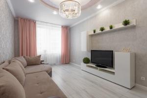 a living room with a couch and a flat screen tv at 3к семейные апартаменты с видом на акваторию in Kazan