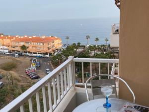 a wine glass sitting on a table on a balcony at CASA CANDELARIA,PARKING,AIR,WIFi in Candelaria