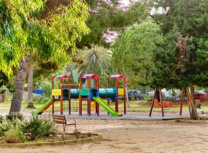 a playground with a slide in a park at Pueblito La Zenia Beach in Orihuela Costa