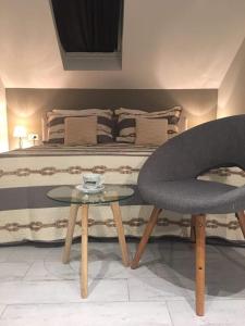 a bedroom with a bed with a table and a chair at Split Center in Split