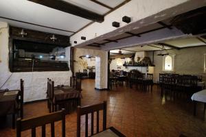 a dining room with tables and chairs in a restaurant at Elbrus Hi Loft Hostel in Elbrus