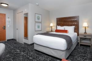 a hotel room with a large bed and two lamps at The Mediterranean Inn in Seattle