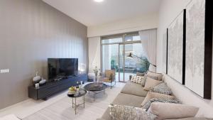 a living room with a couch and a tv at Haneviim Court Luxury by Rental Israel in Jerusalem