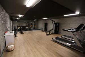 a gym with several treadmills and a brick wall at Good Morning Arlanda in Arlanda