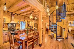 a kitchen and dining room with a table and a staircase at Luxury Mountain Cabin with Furnished Deck and Views! in Loma Linda